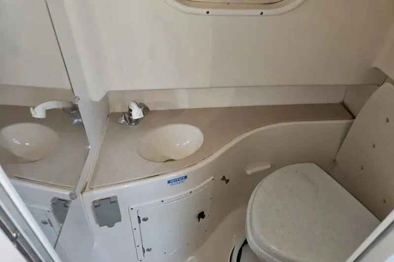2001 Pursuit 2870 Walkaround boat bathroom with sink and toilet.