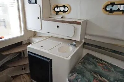 2001 Pursuit 2870 Walkaround boat interior with compact kitchenette and seating area.