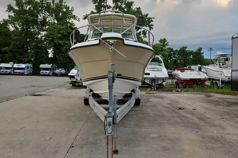 2001 Pursuit 2870 Walkaround boat on trailer in outdoor storage area.