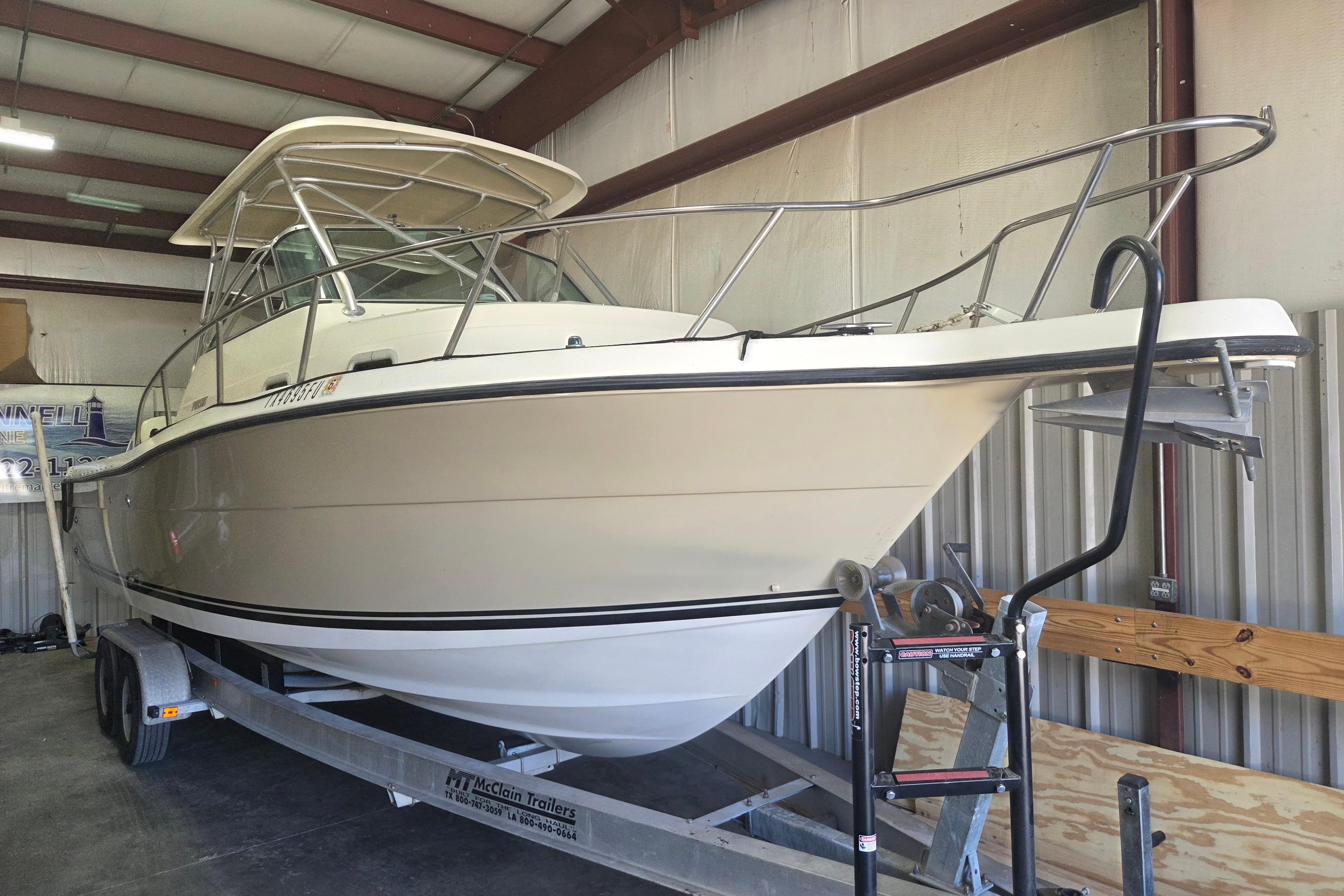 2001 Pursuit 2870 Walkaround boat on trailer in indoor storage.