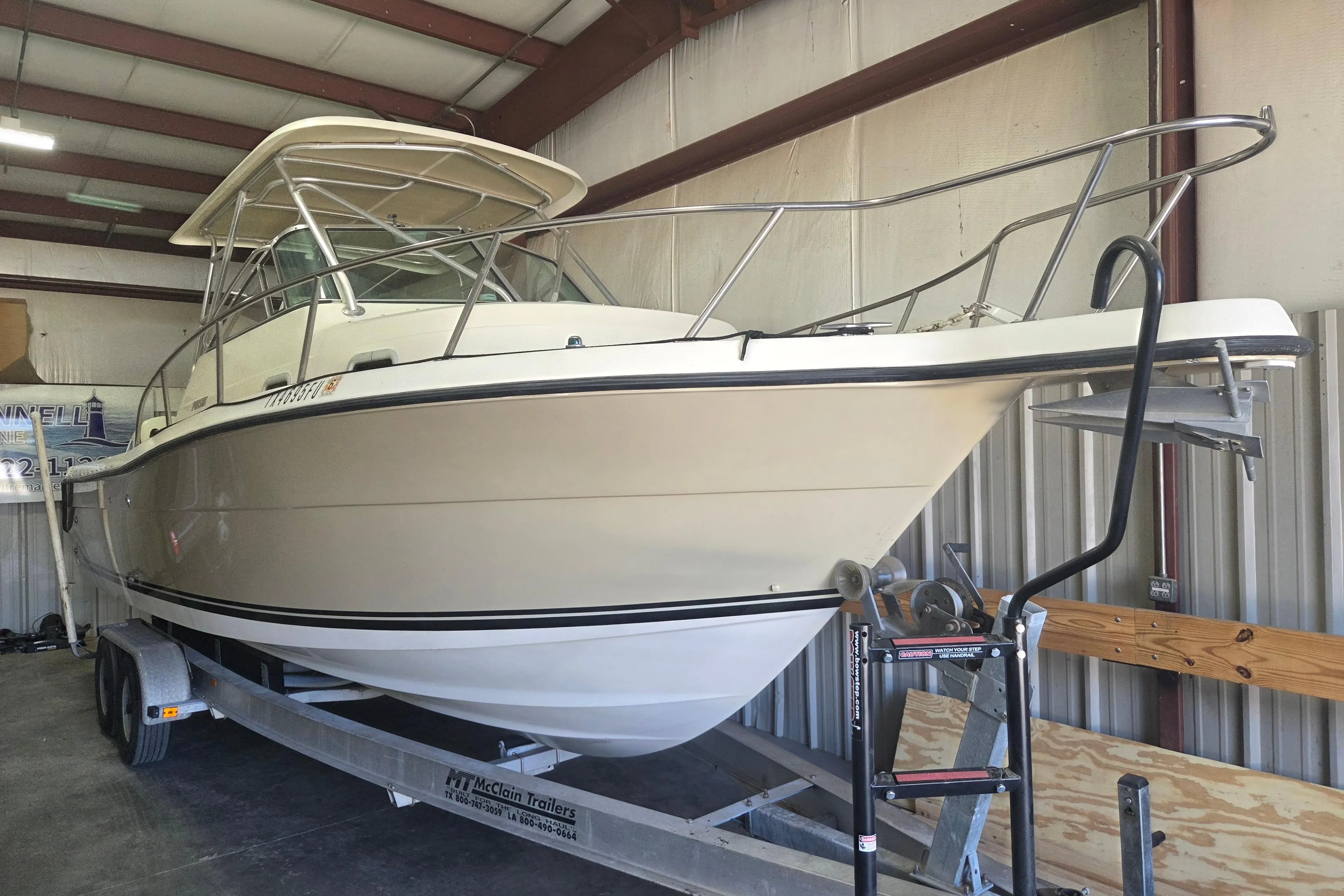 2001 Pursuit 2870 Walkaround boat on trailer in indoor storage.