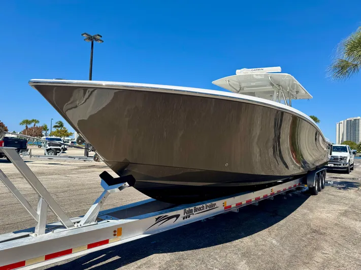 Caryali Yacht Photos Pics 2014 Invincible 42 Open Fisherman boat on trailer under clear blue sky.
