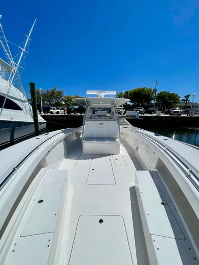 Caryali Yacht Photos Pics 2014 Invincible 42 Open Fisherman boat docked under clear blue sky.