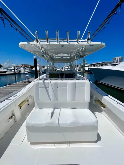 Caryali Yacht Photos Pics 2014 Invincible 42 Open Fisherman boat docked at marina under clear blue sky.