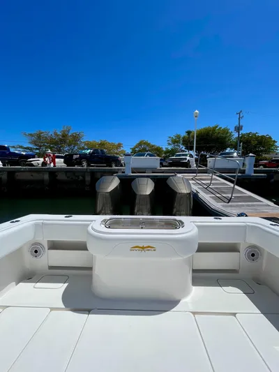 Caryali Yacht Photos Pics 2014 Invincible 42 Open Fisherman boat docked under clear blue sky.