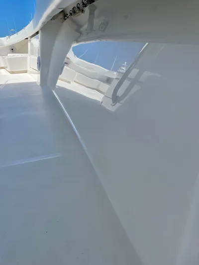 Caryali Yacht Photos Pics 2014 Invincible 42 Open Fisherman boat deck with sleek white finish and clear blue sky.