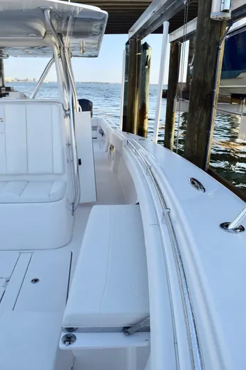 Caryali Yacht Photos Pics 2014 Invincible Open Fisherman boat docked by the water.