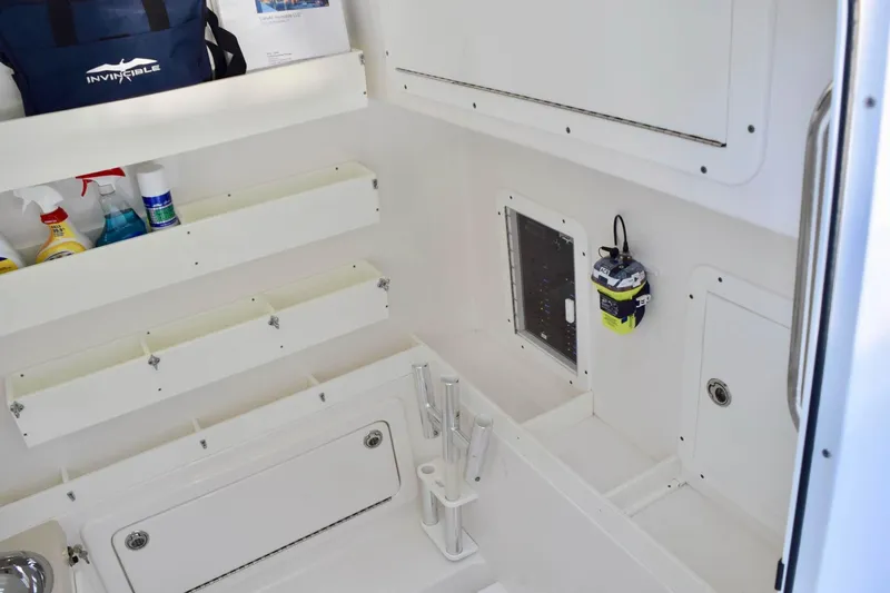 Caryali Yacht Photos Pics 2014 Invincible Open Fisherman boat interior with storage compartments and fishing gear.
