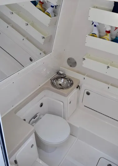 Caryali Yacht Photos Pics 2014 Invincible Open Fisherman boat bathroom with toilet and sink.