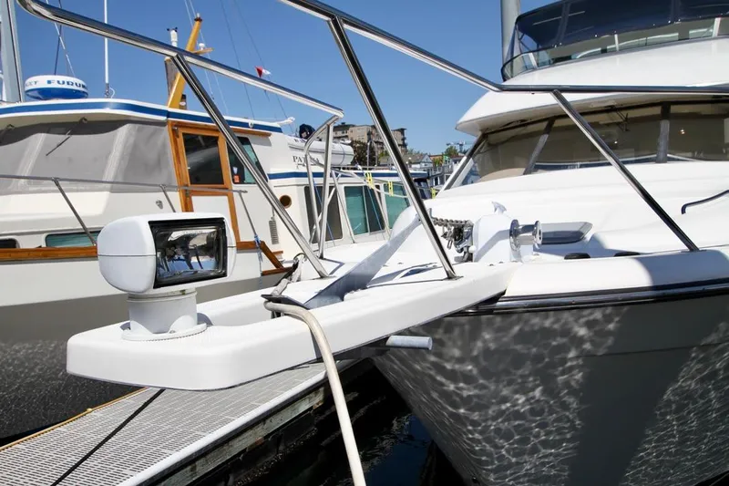  Yacht Photos Pics 2002 Bayliner 3988 yacht docked, featuring a spotlight and railing, with neighboring boats visible.