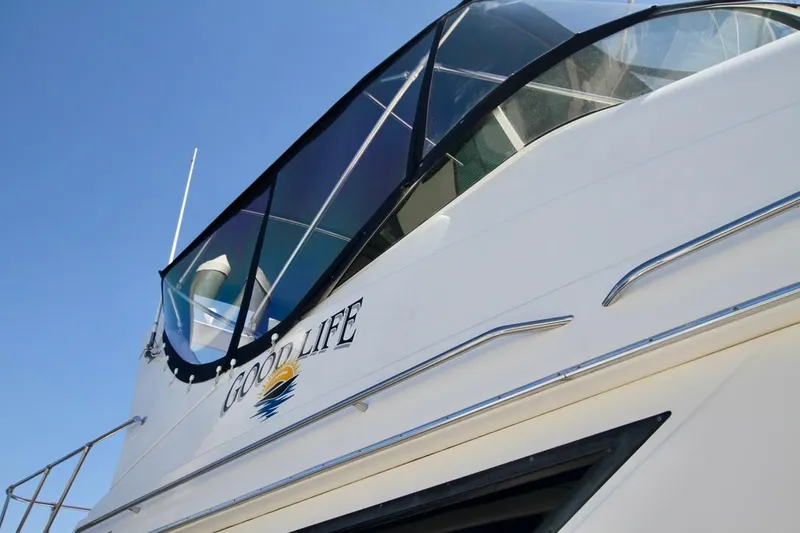  Yacht Photos Pics Bayliner 3988 yacht from 2002 with "Good Life" name, clear blue sky background.