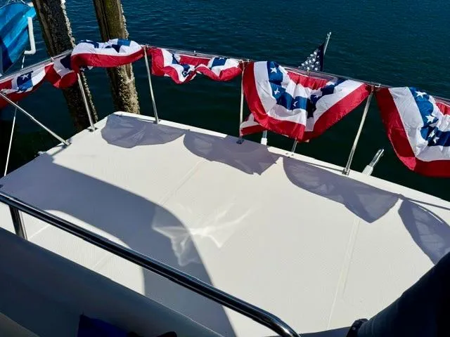  Yacht Photos Pics Bayliner 3988 boat deck with patriotic bunting, 2002 model, docked by the water.