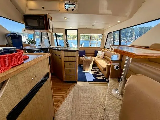  Yacht Photos Pics Interior of 2002 Bayliner 3988 yacht with cozy seating and modern kitchen.