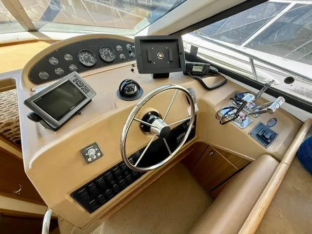  Yacht Photos Pics 2002 Bayliner 3988 helm with steering wheel, navigation instruments, and control panel.