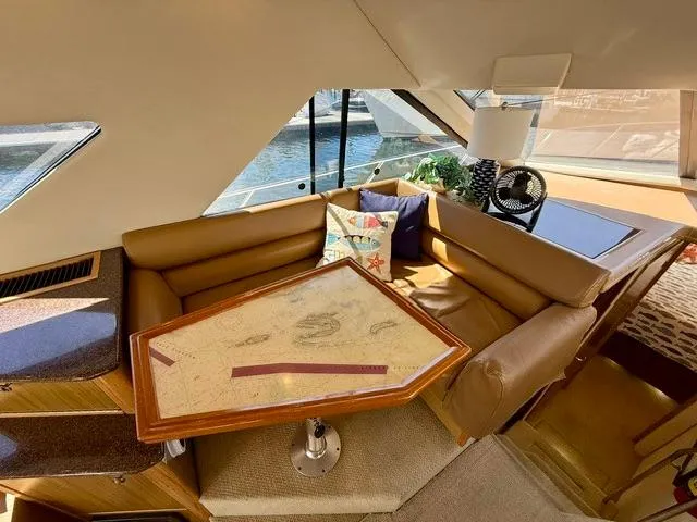  Yacht Photos Pics Interior of 2002 Bayliner 3988 yacht with cozy seating and nautical-themed decor.