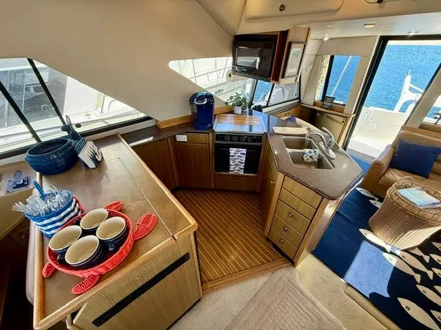  Yacht Photos Pics Luxurious 2002 Bayliner 3988 yacht interior with modern kitchen and ocean view.