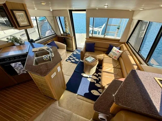  Yacht Photos Pics Luxurious interior of 2002 Bayliner 3988 yacht with spacious seating and modern kitchen.