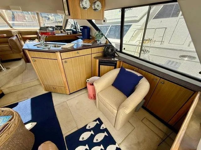  Yacht Photos Pics Interior of 2002 Bayliner 3988 yacht with cozy seating and modern kitchen area.