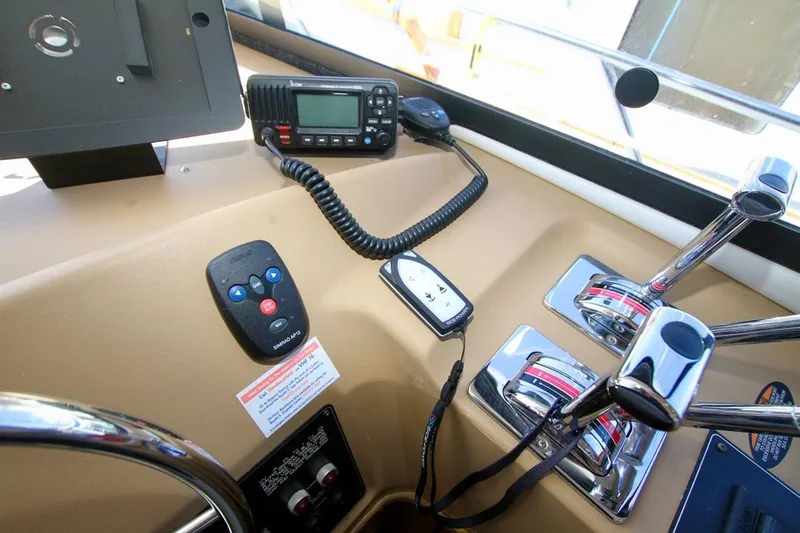 Yacht Photos Pics Control panel of a 2002 Bayliner 3988 boat with radio and throttle levers.