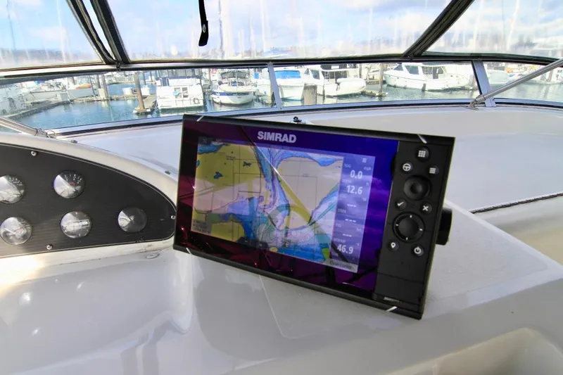  Yacht Photos Pics Bayliner 3988 (2002) helm with Simrad navigation display, docked at marina.