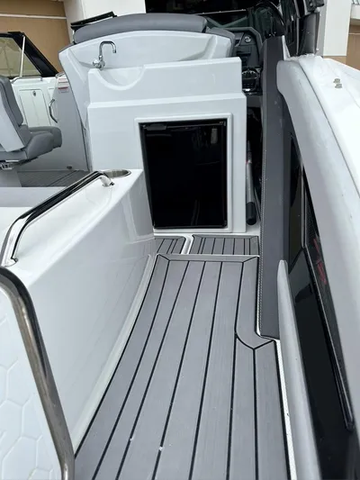 Yacht Photos Pics 2015 Cruisers Sport Series 328 boat interior with open cabin door and seating area.