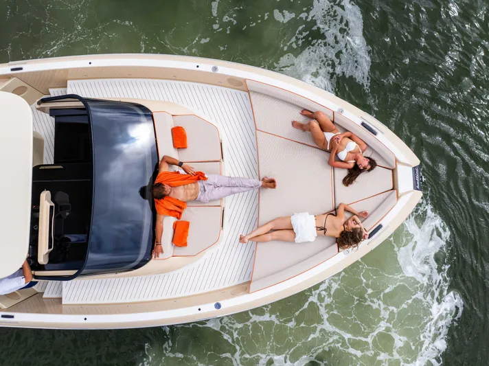  Yacht Photos Pics 2026 Bellini Astor 36 yacht with people sunbathing on deck, cruising on water.