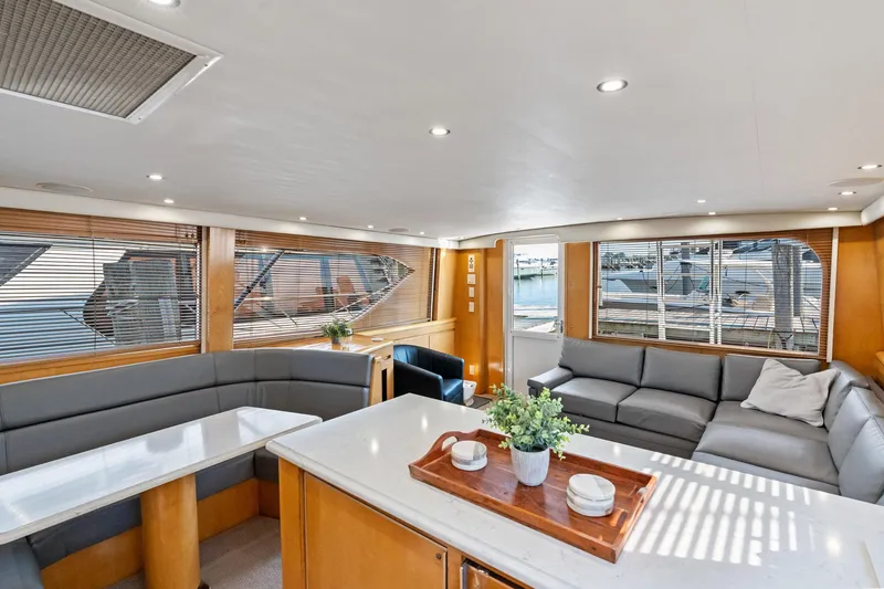 Amp'd Up Yacht Photos Pics Luxurious interior of 1999 Hatteras 60 Convertible yacht with modern seating and decor.