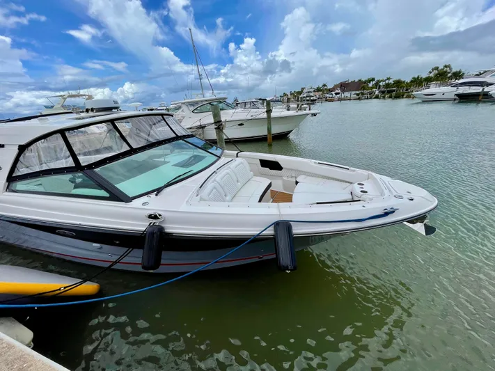  Yacht Photos Pics 2020 Sea Ray SLX boat docked in a marina under a partly cloudy sky.