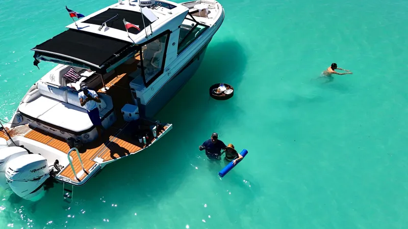  Yacht Photos Pics 2020 Sea Ray SLX boat in turquoise water with people swimming nearby.
