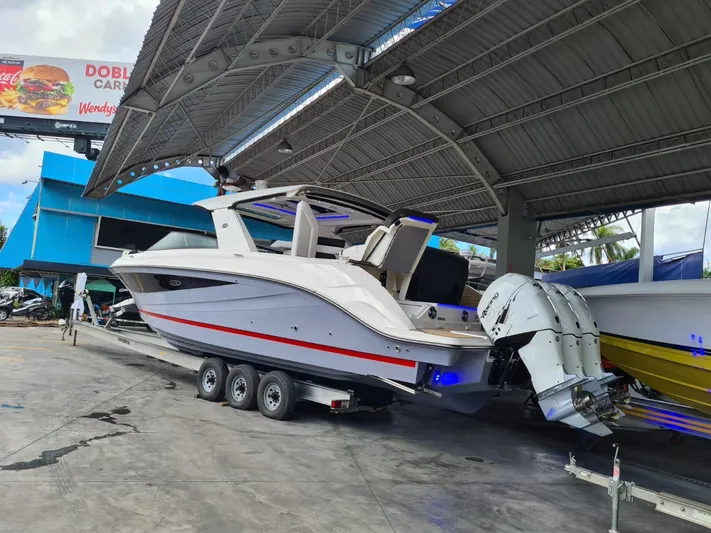  Yacht Photos Pics 2020 Sea Ray SLX boat on trailer under a metal canopy.