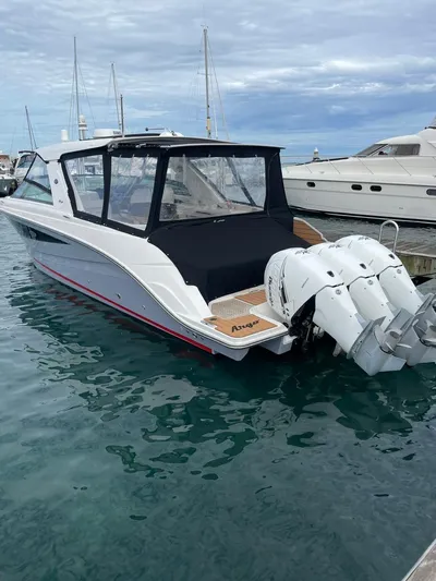  Yacht Photos Pics 2020 Sea Ray SLX boat docked with twin outboard engines, featuring sleek design and covered seating.