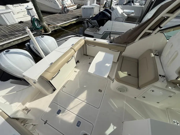  Yacht Photos Pics 2017 Pursuit DC 325 Dual Console boat interior with seating and storage compartments.
