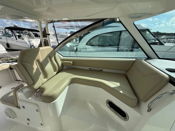  Yacht Photos Pics 2017 Pursuit DC 325 Dual Console interior with beige seating and marina view.