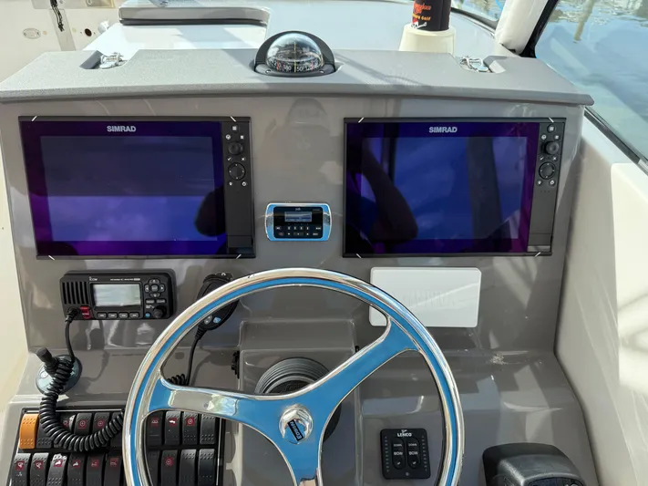 Yacht Photos Pics 2017 Pursuit DC 325 Dual Console helm with dual Simrad displays and steering wheel.