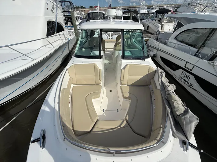  Yacht Photos Pics 2017 Pursuit DC 325 Dual Console boat docked among other vessels.