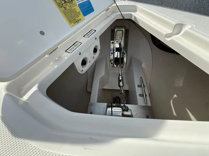  Yacht Photos Pics Anchor compartment of 2017 Pursuit DC 325 Dual Console boat, featuring chain and controls.