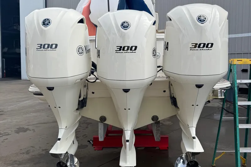  Yacht Photos Pics 2019 Scout 350 LXF with triple Yamaha 300 outboard engines in a marina setting.