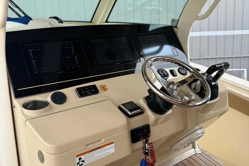  Yacht Photos Pics 2019 Scout 350 LXF boat dashboard with steering wheel and control panels.