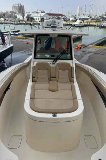  Yacht Photos Pics 2019 Scout 350 LXF boat with beige seating, docked at a marina.