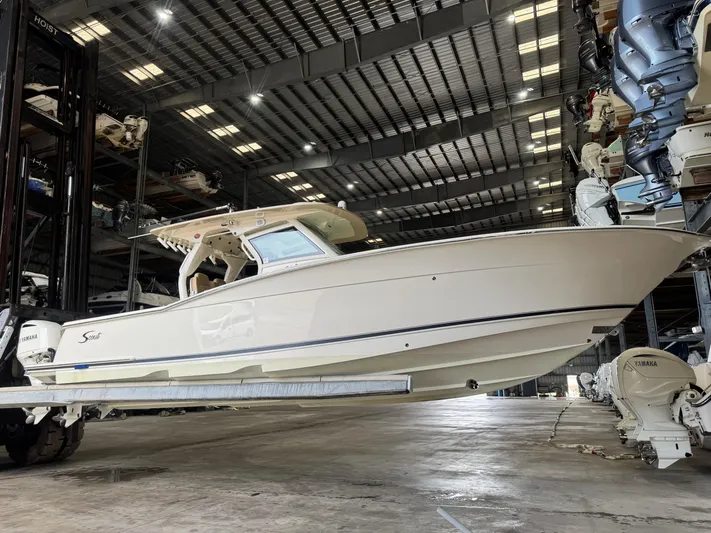  Yacht Photos Pics 2019 Scout 350 LXF boat in storage facility, side view with Yamaha engines.
