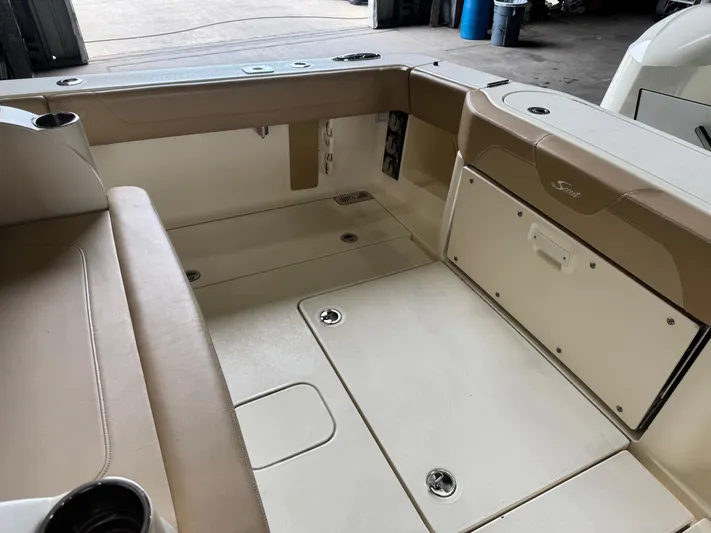  Yacht Photos Pics 2019 Scout 350 LXF boat interior with beige seating and storage compartments.