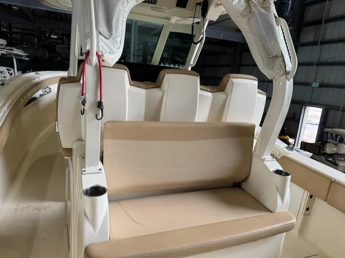  Yacht Photos Pics 2019 Scout 350 LXF boat interior with beige seating and cup holders.