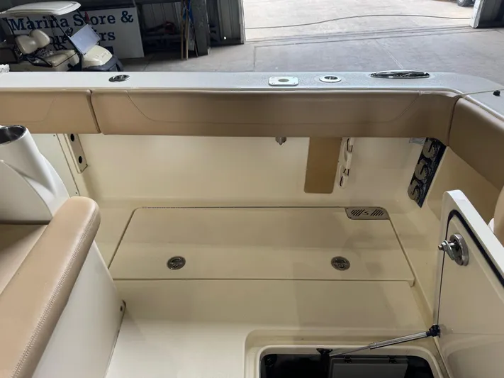  Yacht Photos Pics 2019 Scout 350 LXF boat interior with beige seating and storage compartments.
