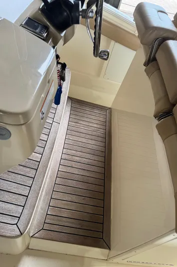  Yacht Photos Pics 2019 Scout 350 LXF boat interior with wooden flooring and beige seating.