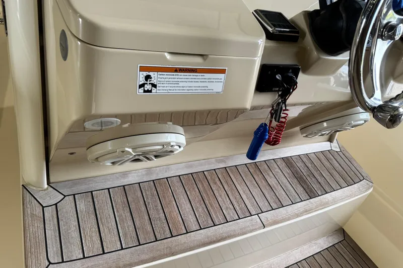 Yacht Photos Pics 2019 Scout 350 LXF boat dashboard with steering wheel, warning label, and wooden flooring.