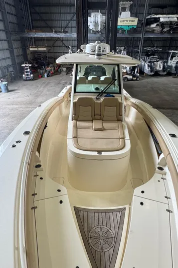  Yacht Photos Pics 2019 Scout 350 LXF boat interior with seating and Garmin equipment in a storage facility.