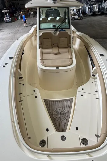  Yacht Photos Pics 2019 Scout 350 LXF boat interior with seating and deck, in a storage facility.