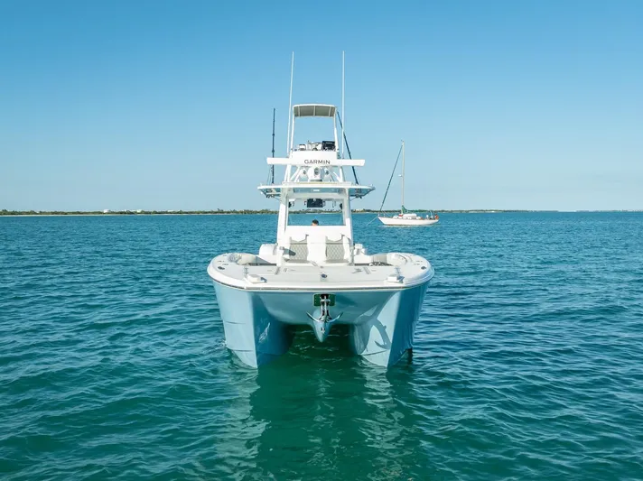 Yacht Photos Pics 2023 Invincible 37 Catamaran on calm blue waters, front view.