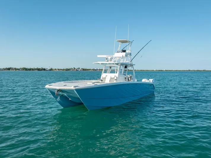  Yacht Photos Pics 2023 Invincible 37 Catamaran on clear blue water, showcasing sleek design and advanced features.