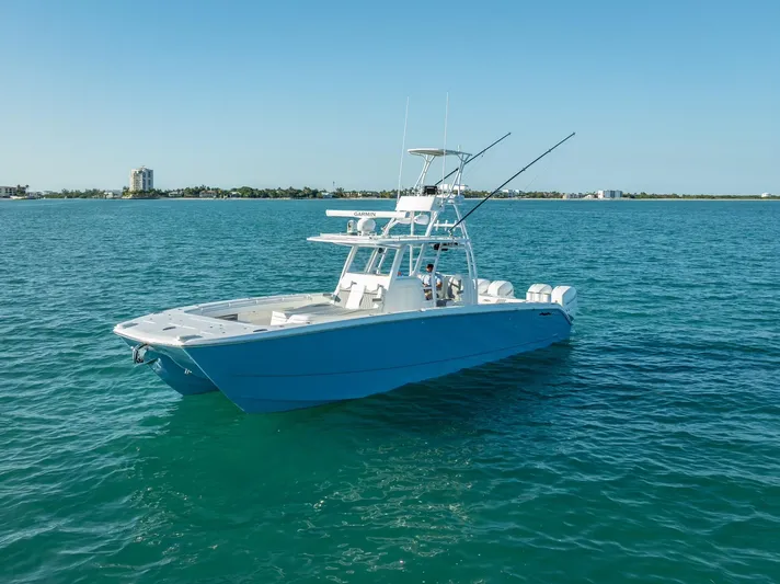  Yacht Photos Pics 2023 Invincible 37 Catamaran on clear blue water, showcasing sleek design and fishing capabilities.